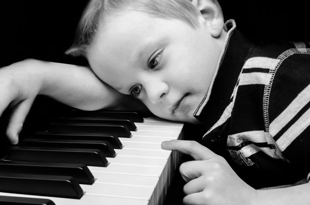 Child playing piano. Music Student Motivation lacking
