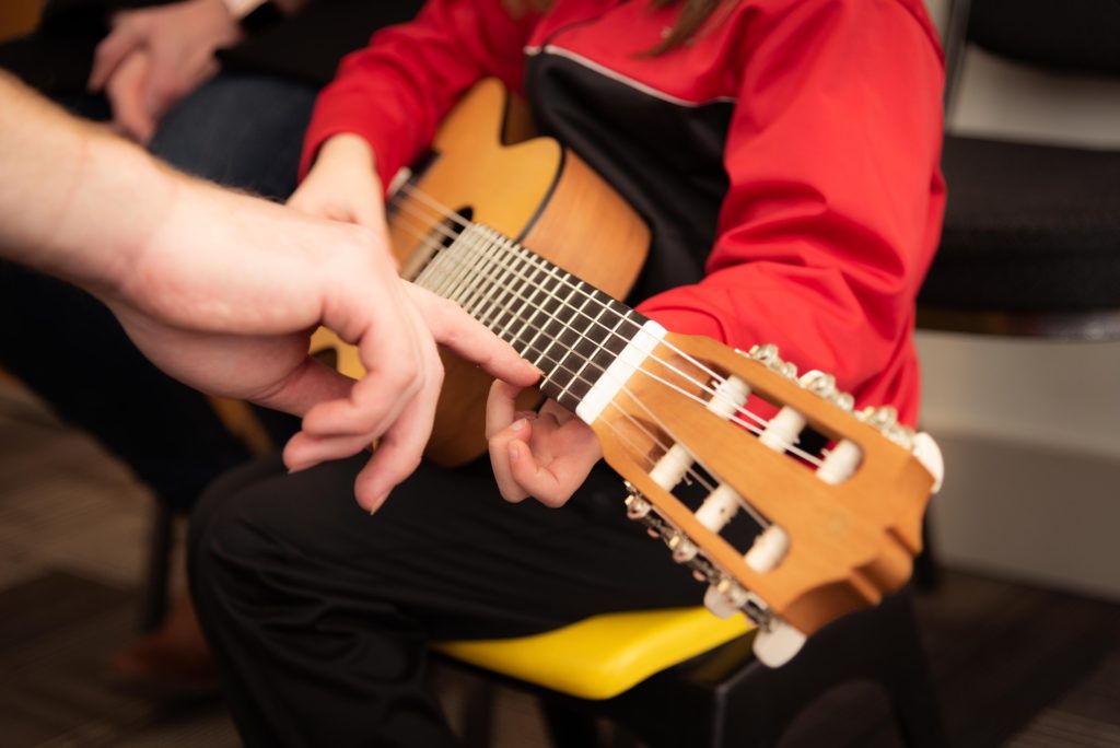 Teaching child to play the guitar